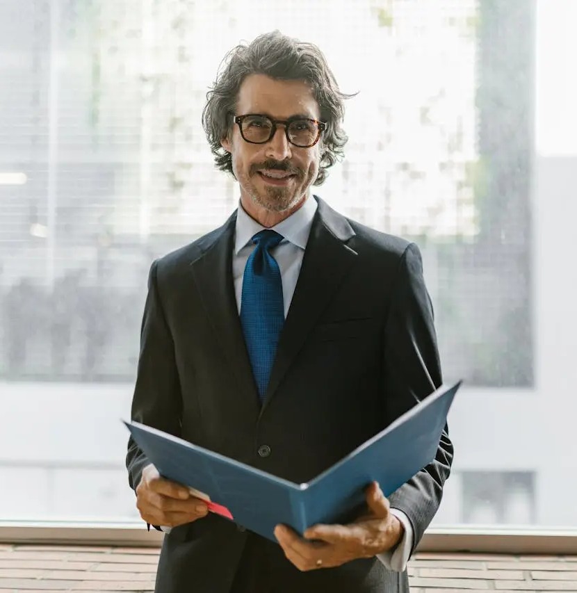 corporate-man-holding-a-file-smiling