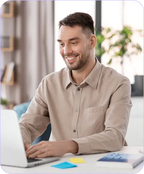 Man sitting on a chair and using laptop on the desk