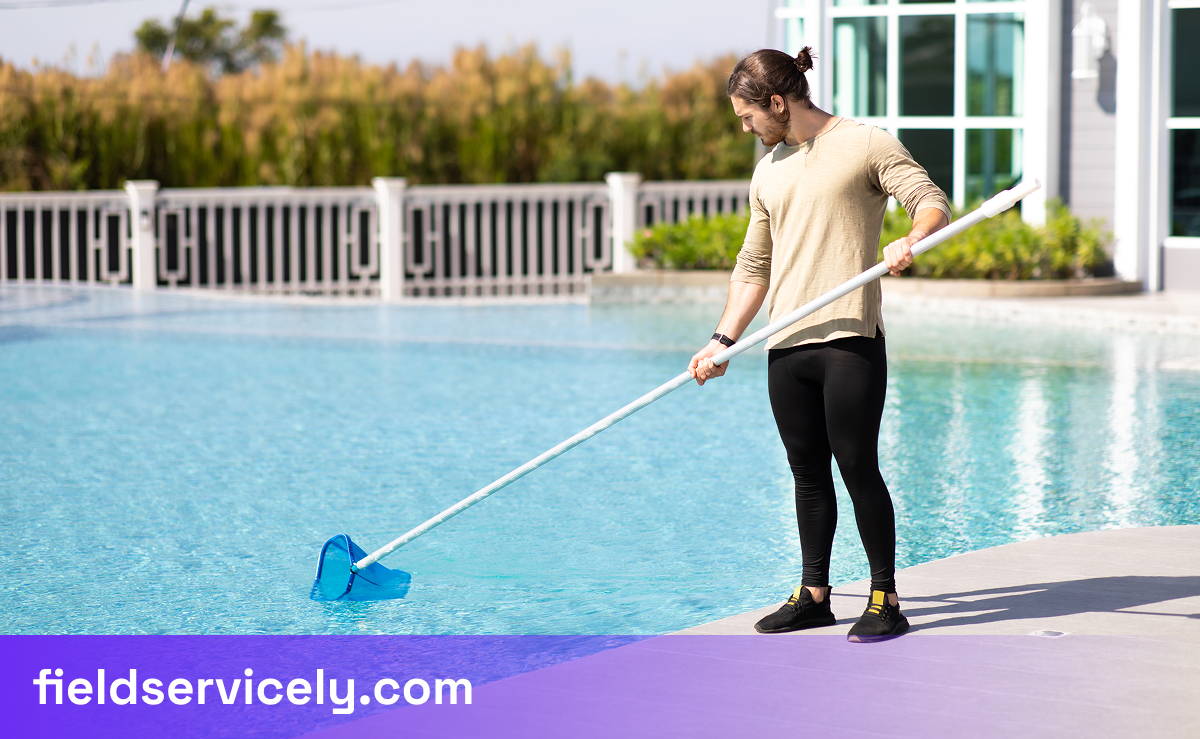 A worker cleaning the pool