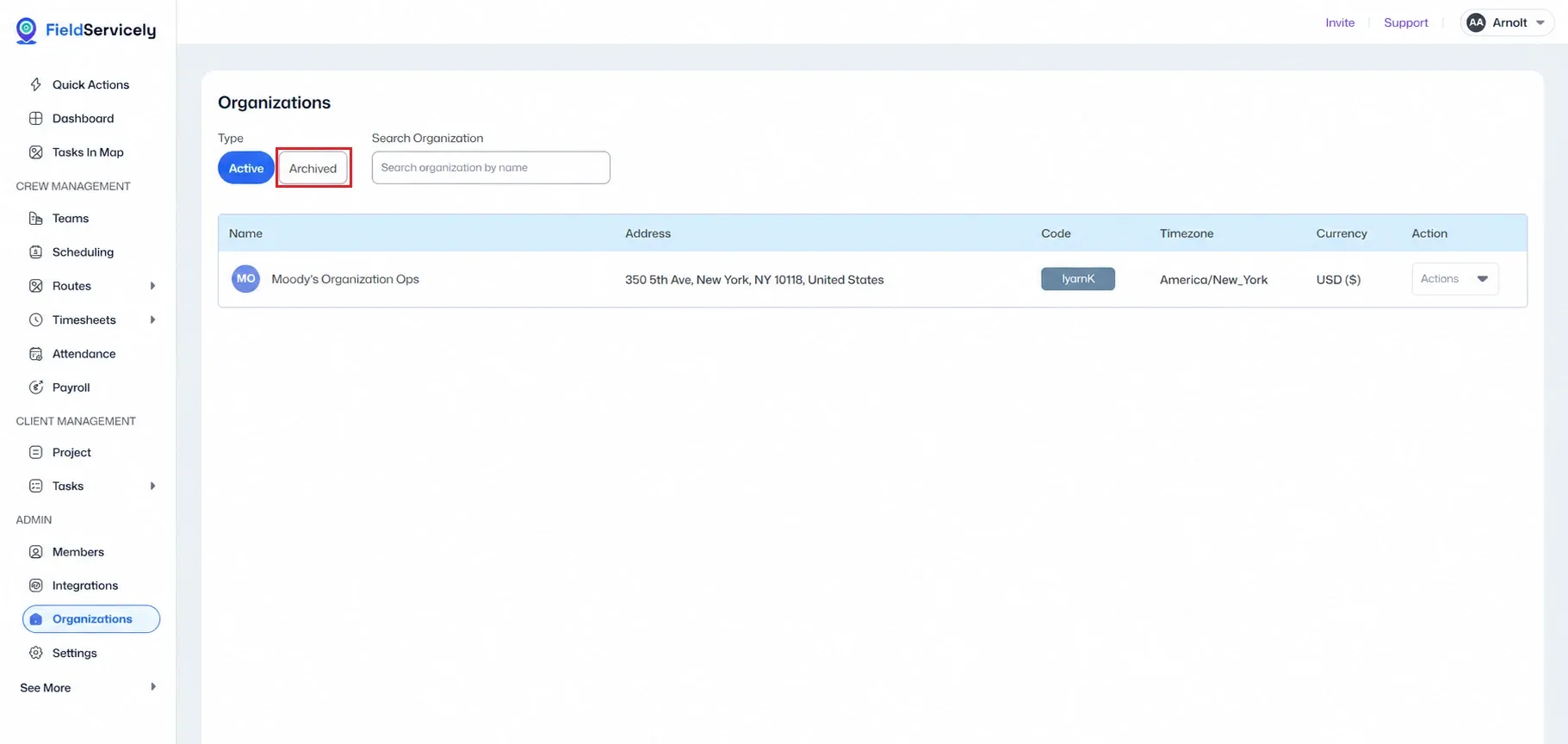 FieldServicely Organizations page showing Active and Archived type tabs, search organization field, and an organization table with name, address, code, timezone, currency, and actions. The Archived tab is highlighted in red for unarchive guidance.
