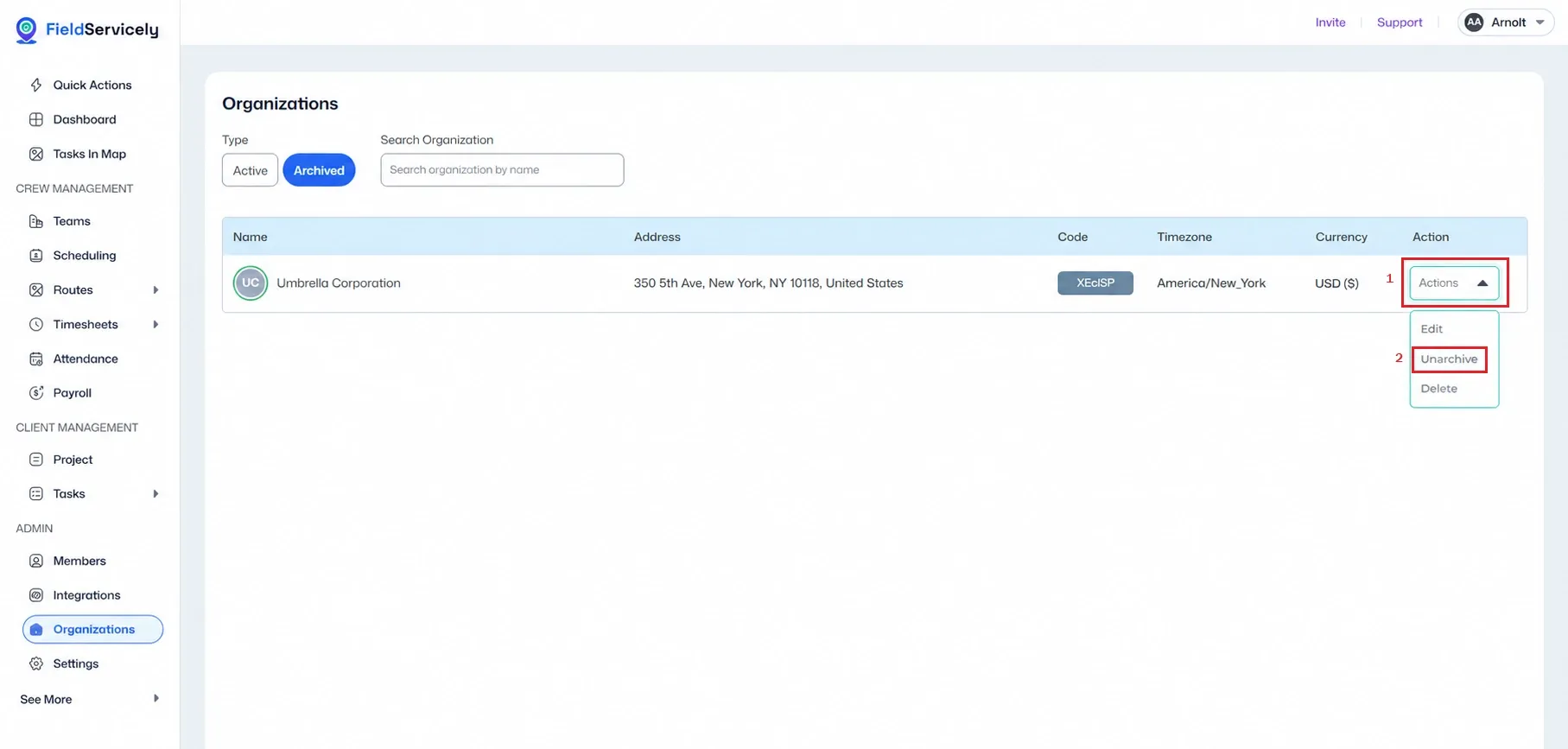 FieldServicely Organizations page with Archived tab selected, showing Umbrella Corporation in the organization table. The Actions dropdown is open on the right, with Unarchive highlighted in red to guide restoring an archived organization.